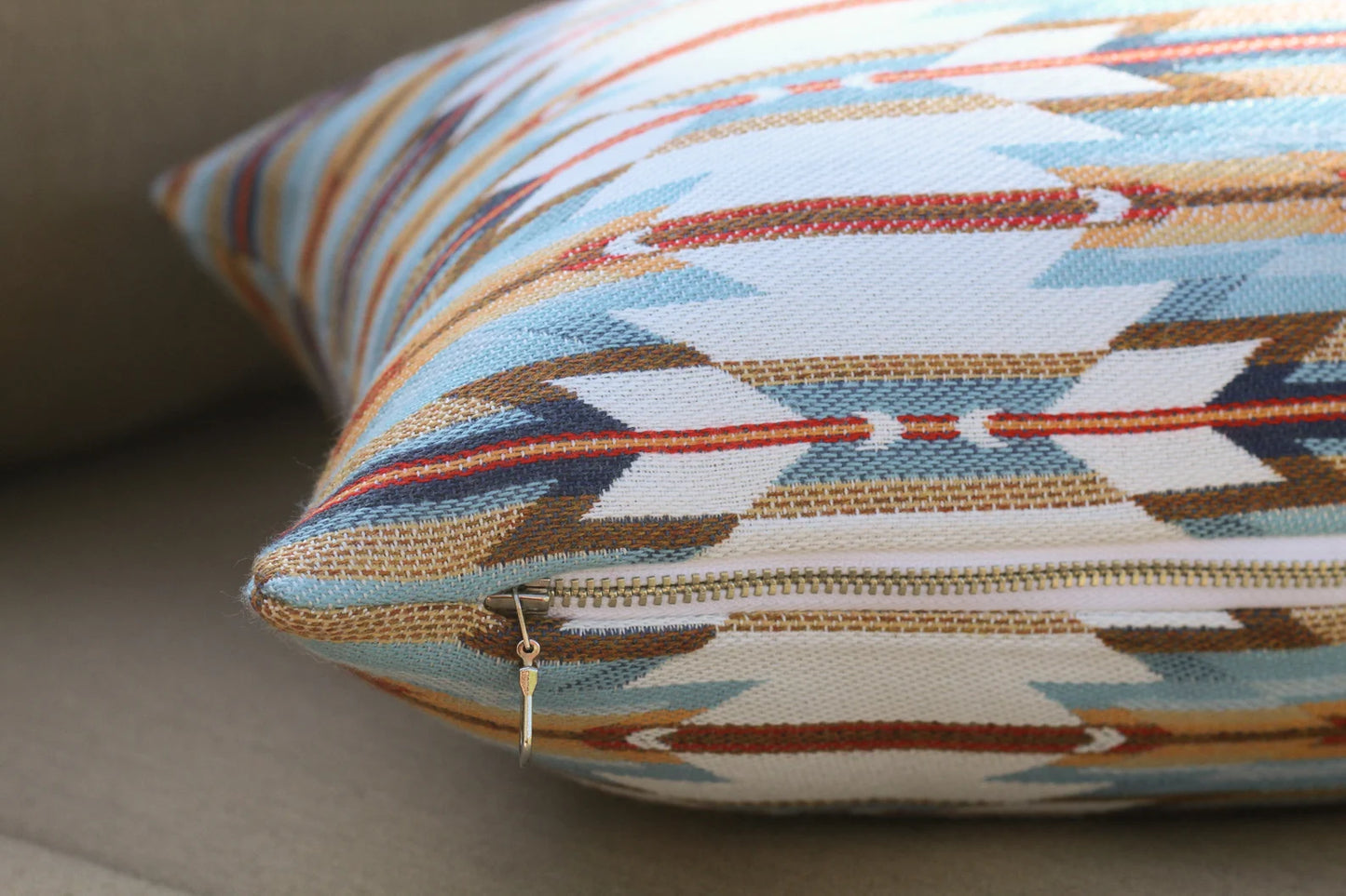 Decorative pillow in thegeometric Wyeth Trail Sunset pattern on a neutral background