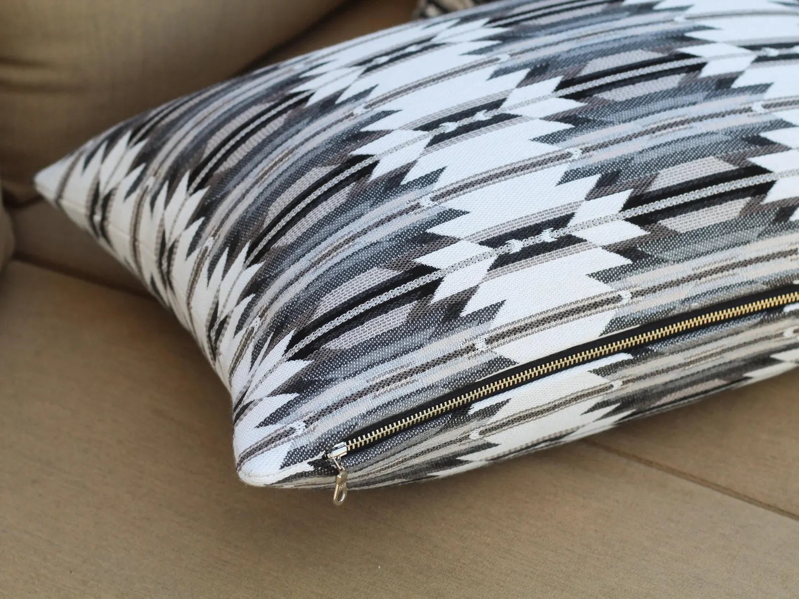 Close up of zipper on outdoor pillow in the black, gray, and white southwestern Wyeth Trail Stone pattern