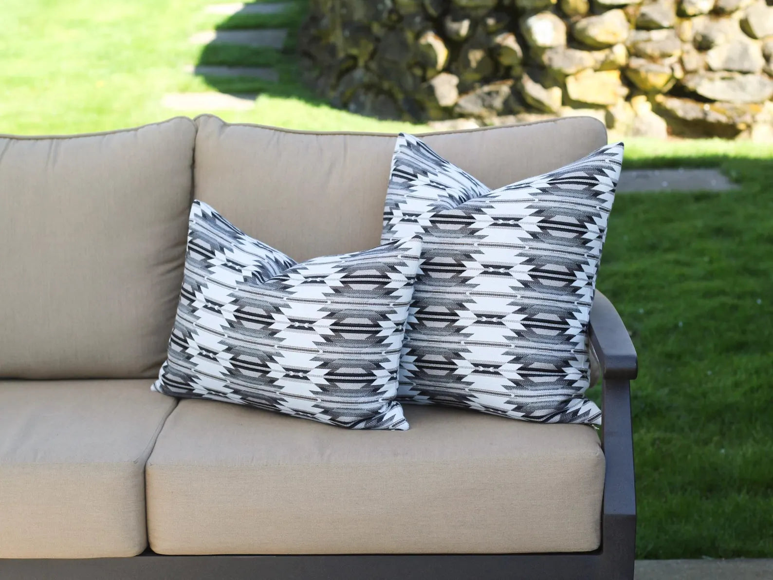 Two outdoor pillows in the black, gray, and white southwestern Wyeth Trail Stone pattern