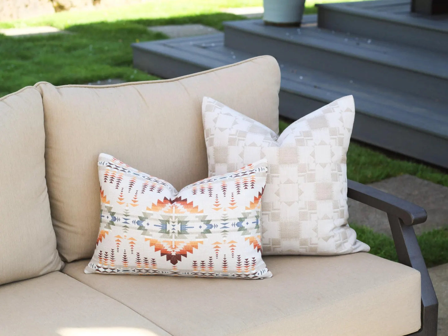 Beige outdoor sofa with outdoor pillow covers on a patio