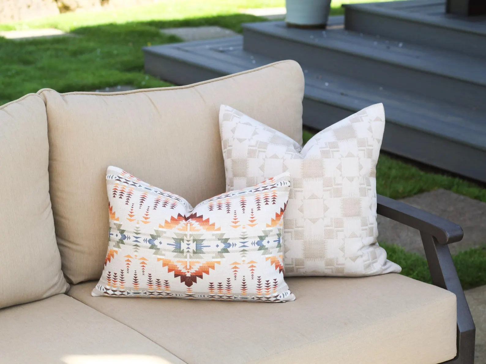 Beige outdoor sofa with outdoor pillow covers on a patio