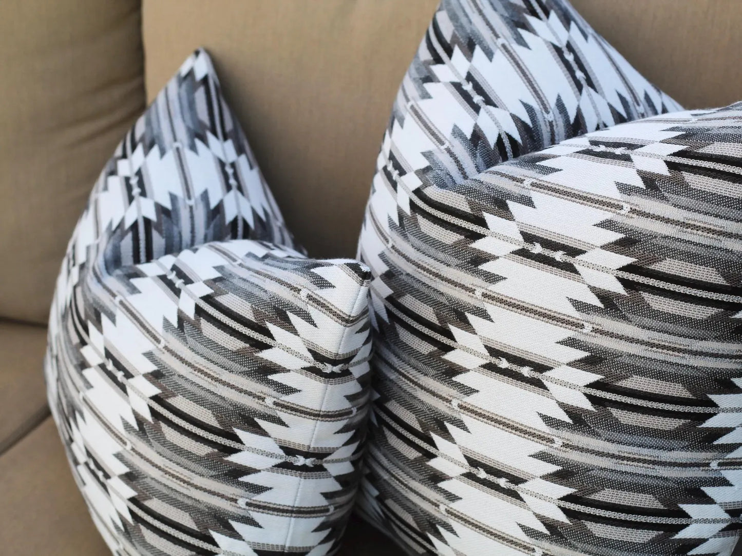 Close up of two outdoor pillows in the black, gray, and white southwestern Wyeth Trail Stone pattern