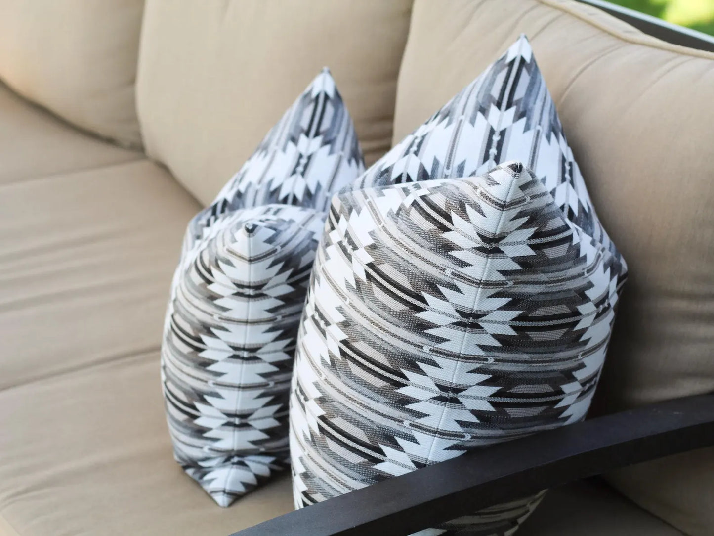 Close up of two outdoor pillows in the black, gray, and white southwestern Wyeth Trail Stone pattern